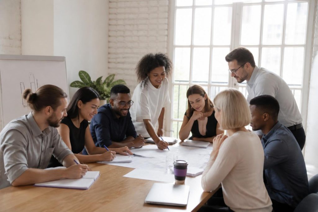 A group of people sitting around a table discussing.