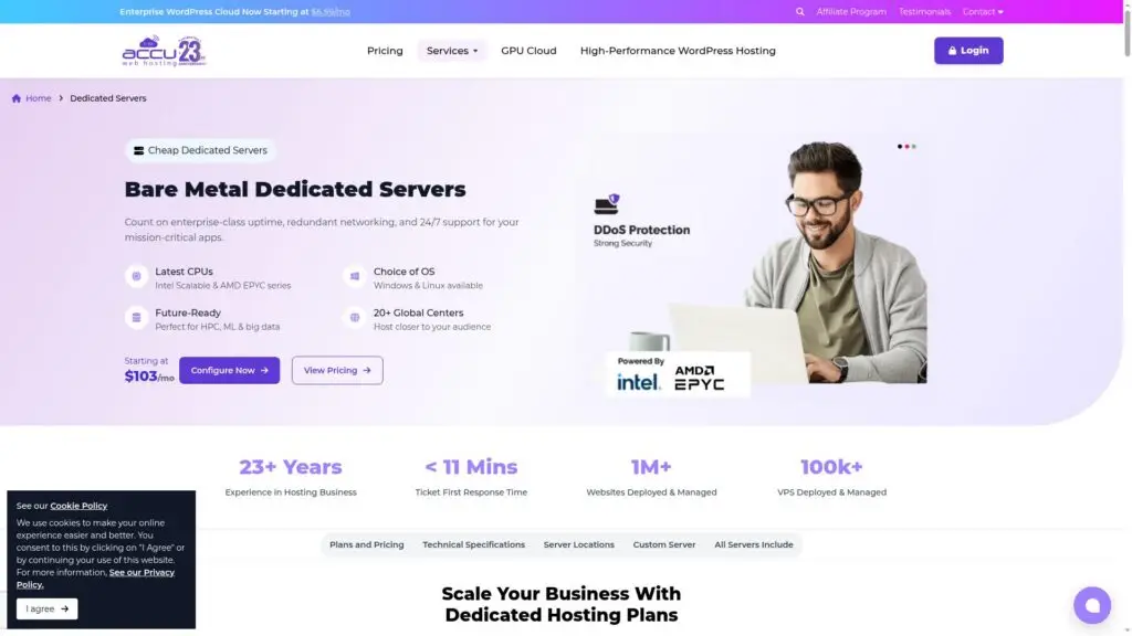 A man is working on a laptop with information about dedicated servers.