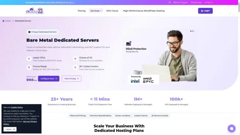 A man is working on a laptop with information about dedicated servers.