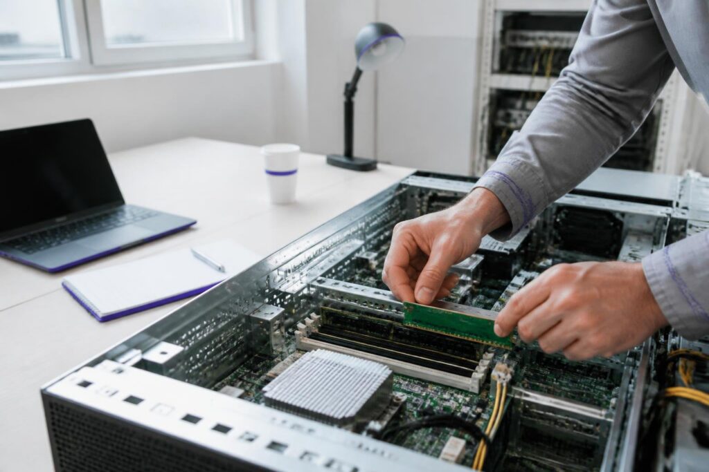 A person is working on server hardware in an office.