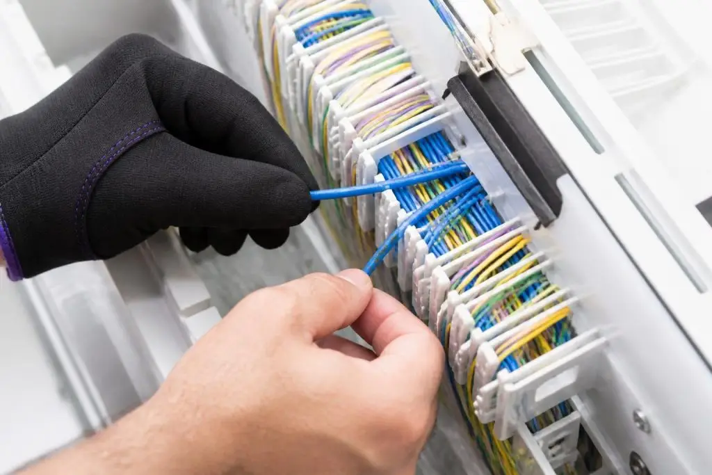 A person is working on a cable management system.